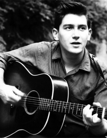 Black and white photograph of folksinger Phil Ochs.