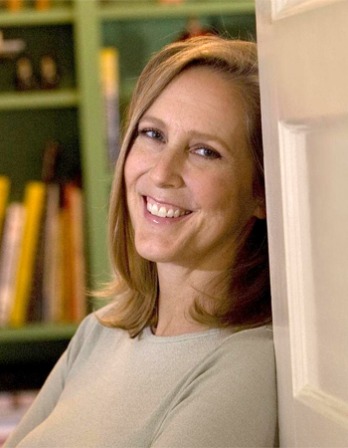 Mary Roach Color photograph of American writer Mary Roach leaning on door.