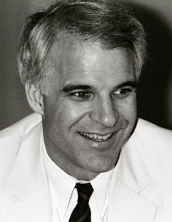 black and white photo of Steve Martin wearing a white dinner jacket and black tie