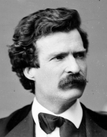 Black and white photograph of a young Mark Twain with dark hair.