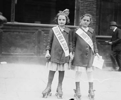 Photo showing two young girls on roller skates wearing sashes that read, “Don’t Be a Scab.”