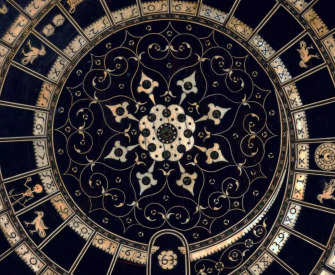 Black game board with circular gold pattern.