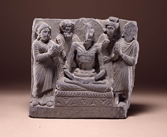 An emaciated Bodhisattva seated on a throne flanked by gods and worshippers, second to third century, Gandhara. The British Museum.