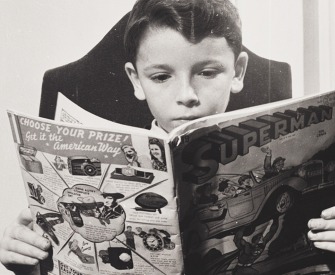 A German refugee child reads a Superman comic, 1942