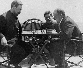 Vladimir Lenin (right) plays chess with Alexander Bogdanov (left) during a visit to Maxim Gorky (center), 1908.