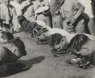 Marines stationed in North China participate in a pie-eating contest, c. 1941. Ray S. Robinson Collection (COLL/1940), U.S. Marine Corps Archives & Special Collections.