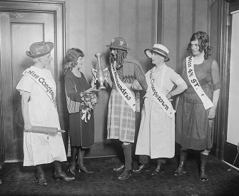 Photograph of Margaret Gorman presenting the wooden cup to the winner of the Advertising Club’s “beauty” contest, 1921.