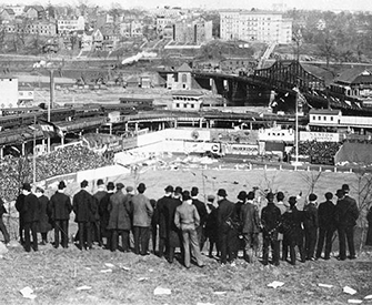 Baseball fans stand on Coogan’s Bluff to watch the New York Giants play the Chicago Cubs, Polo Grounds, New York City, September 23, 1908.