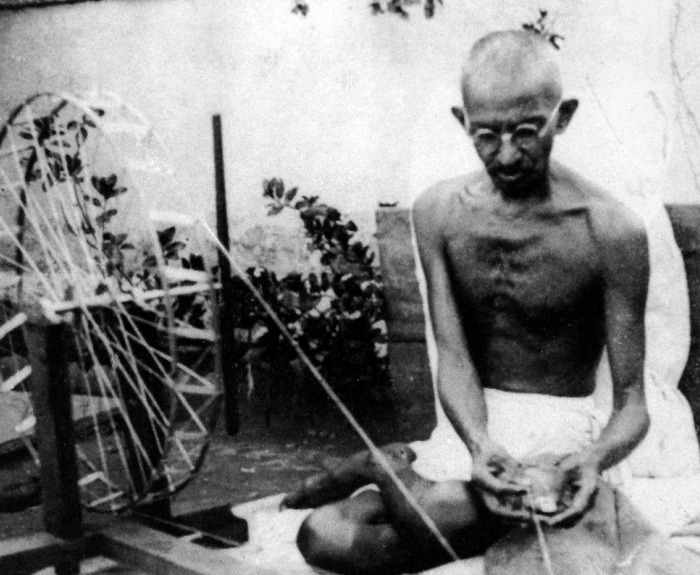 Mahatma Gandhi spinning yarn, in the late 1920s