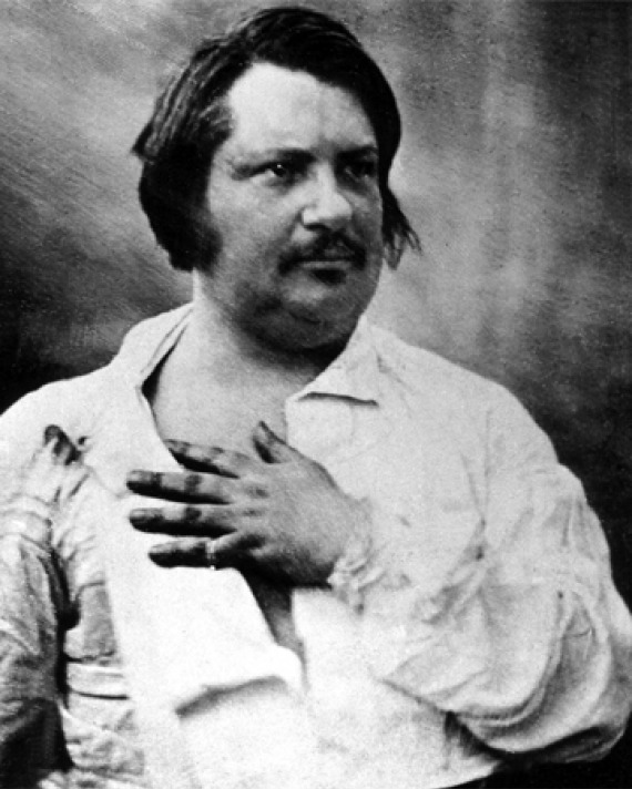 Image of French writer Honoré de Balzac with hand on chest.