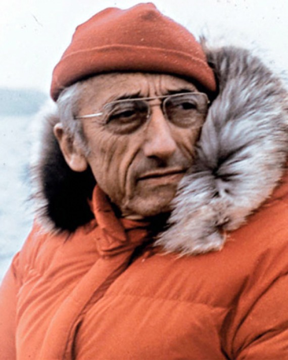 Color photograph of French oceanic explorer Jacques Cousteau in parka.