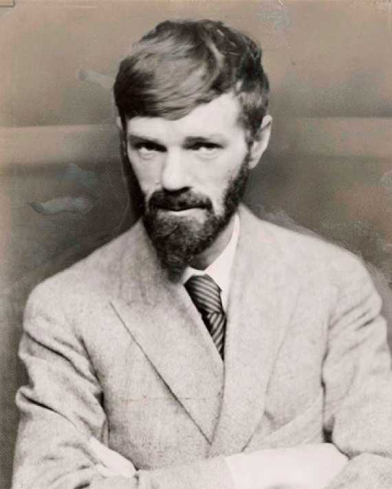 Black and white photograph of D.H. Lawrence with arms crossed.