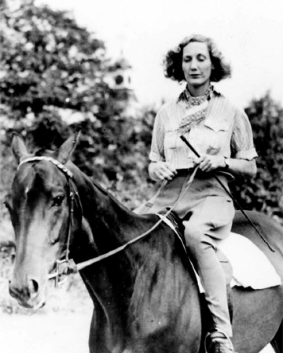 Photograph of pilot, horse trainer, writer, and adventurer Beryl Markham on horseback.
