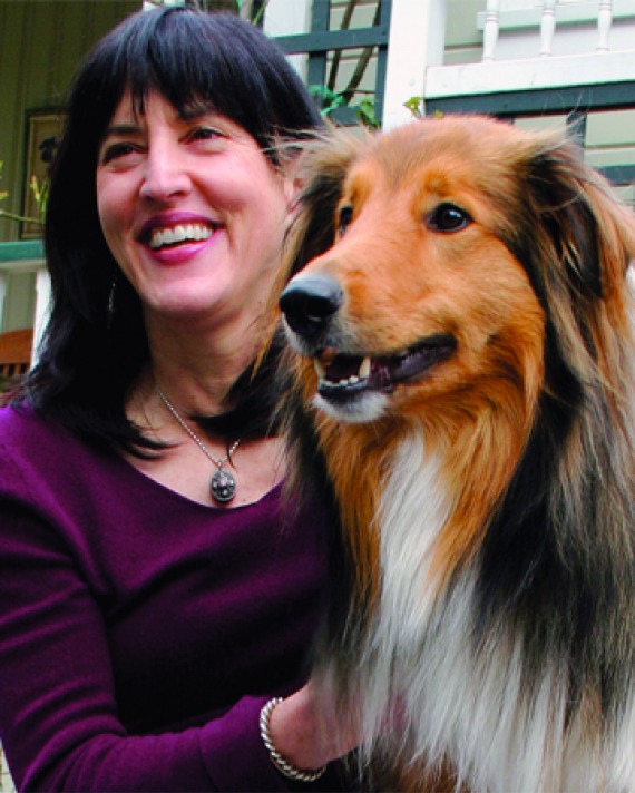 Photograph of American science writer Virginia Morell with dog.