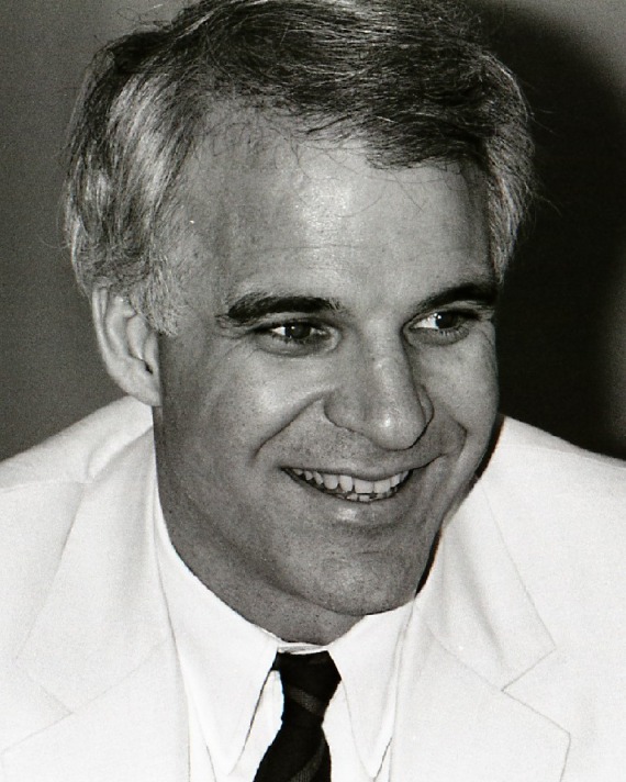 black and white photo of Steve Martin wearing a white dinner jacket and black tie