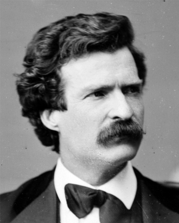 Black and white photograph of a young Mark Twain with dark hair.