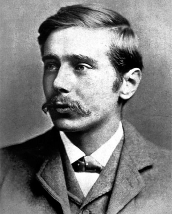 Black and white photograph of a young H.G. Wells with a mustache.