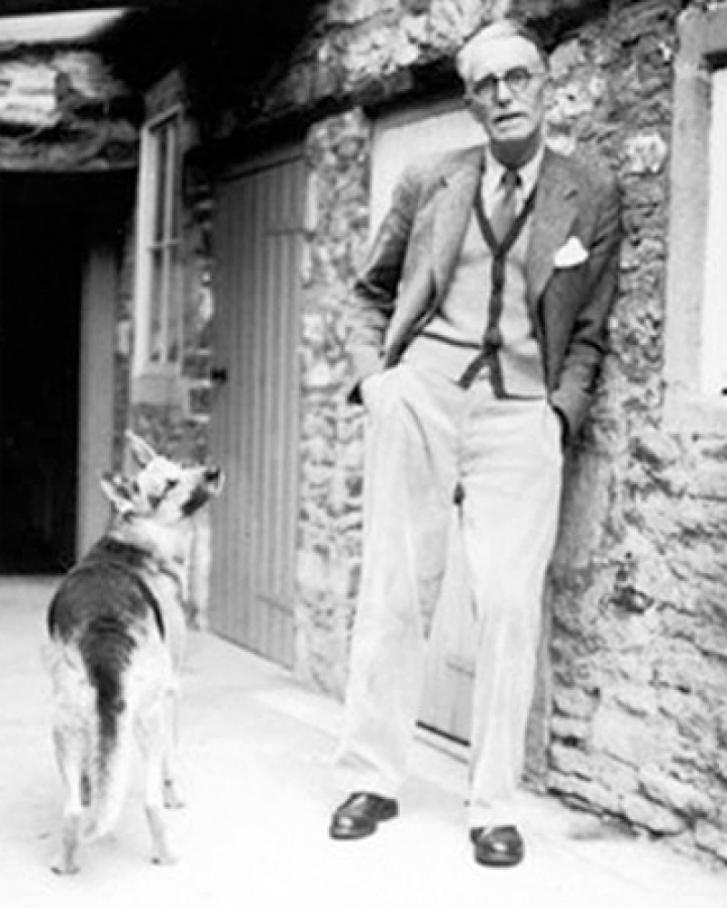 Photograph of British novelist and editor J.R. Ackerley with dog.