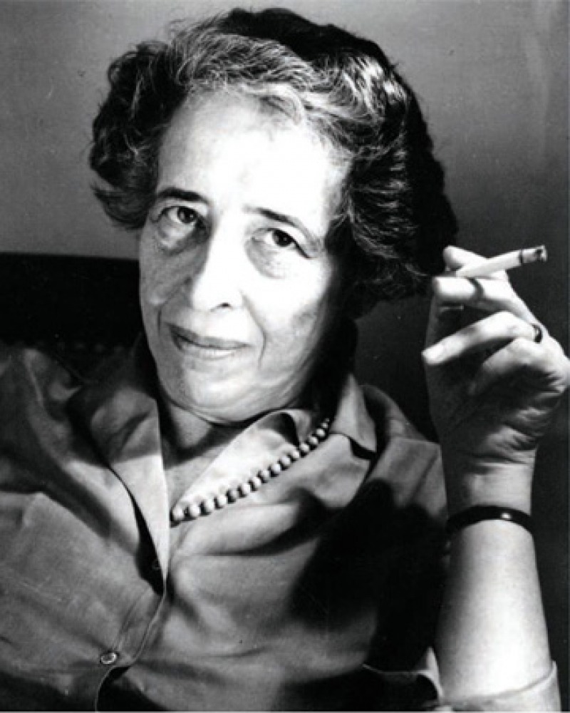 Black and white photograph of political scientist and philosopher Hannah Arendt holding a cigarette.