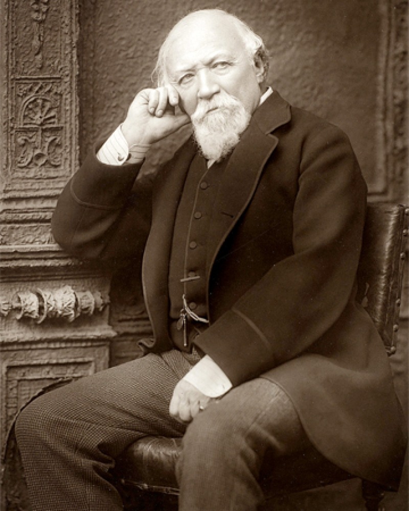 Black and white photograph of English poet Robert Browning seated.