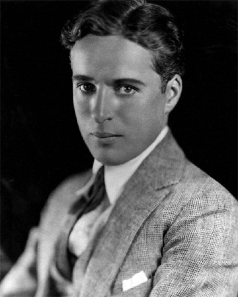 Studio headshot of a young Charlie Chaplin without his signature mustache.