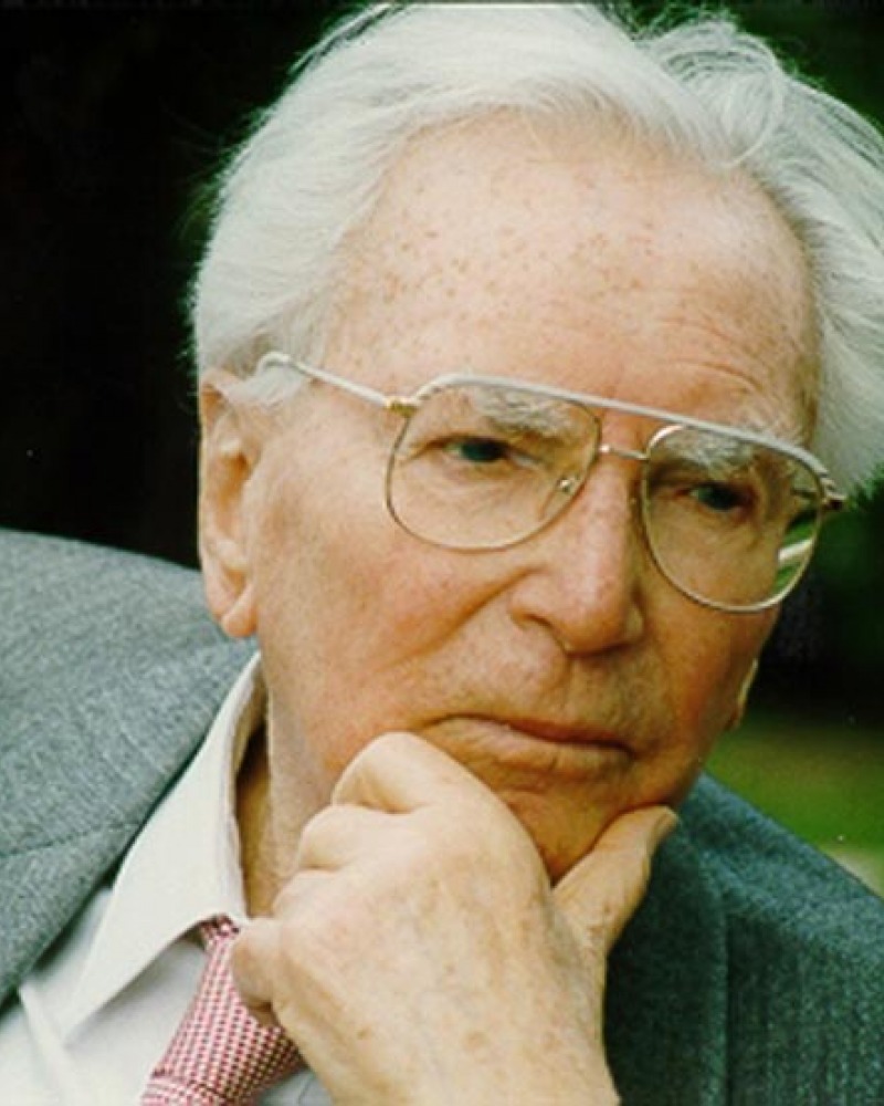 color photograph of Victor Frankl with his hand on his chin looking pensive