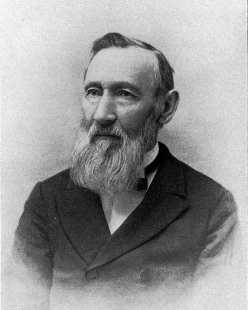 Portrait of George Vasey in a suit with a long white beard