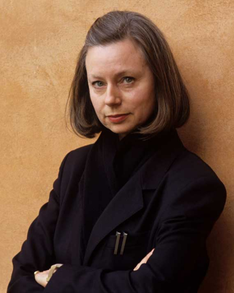 Woman standing against a wall with her arms crossed