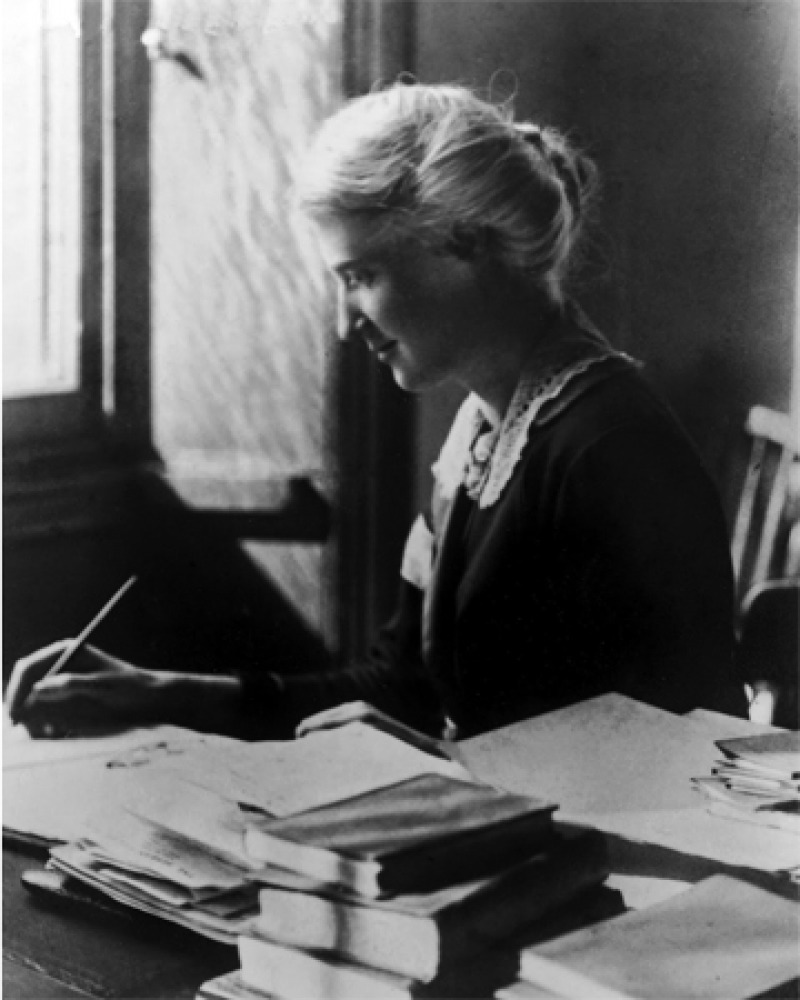 Black and white photograph of British social reformer Eglantyne Jebb at a desk.