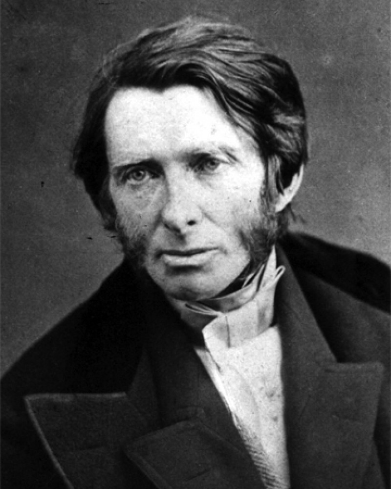 Black and white photograph of a young John Ruskin wearing a suit.