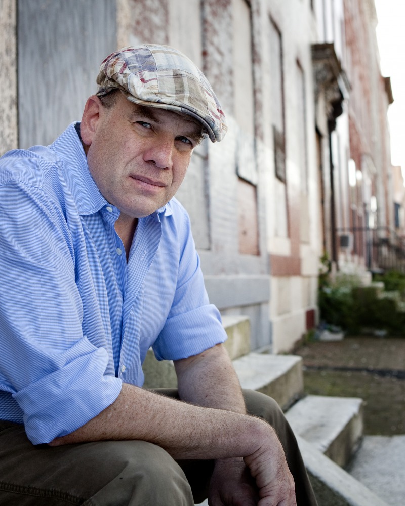 David Simon sitting outside wearing an Irish driver cap