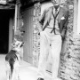 Photograph of British novelist and editor J.R. Ackerley with dog.
