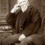Black and white photograph of English poet Robert Browning seated.