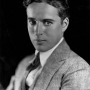 Studio headshot of a young Charlie Chaplin without his signature mustache.