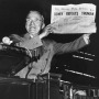 Black and white photo of Harry S. Truman holding a newspaper with the headline "Dewey defeats Truman"