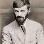 Black and white photograph of D.H. Lawrence with arms crossed.