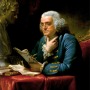 Painting of Benjamin Franklin reading a batch of papers next to a classical bust.