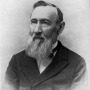 Portrait of George Vasey in a suit with a long white beard