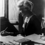 Black and white photograph of British social reformer Eglantyne Jebb at a desk.