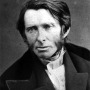 Black and white photograph of a young John Ruskin wearing a suit.