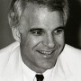 black and white photo of Steve Martin wearing a white dinner jacket and black tie