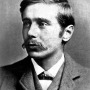 Black and white photograph of a young H.G. Wells with a mustache.