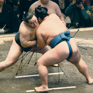 Two sumo wrestlers fighting.