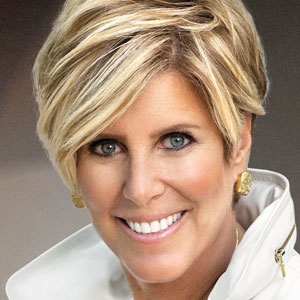 A photograph of Suze Orman. She has gold earrings and short blond hair.