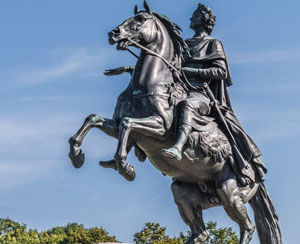 A bronze monument of a man on a horse.